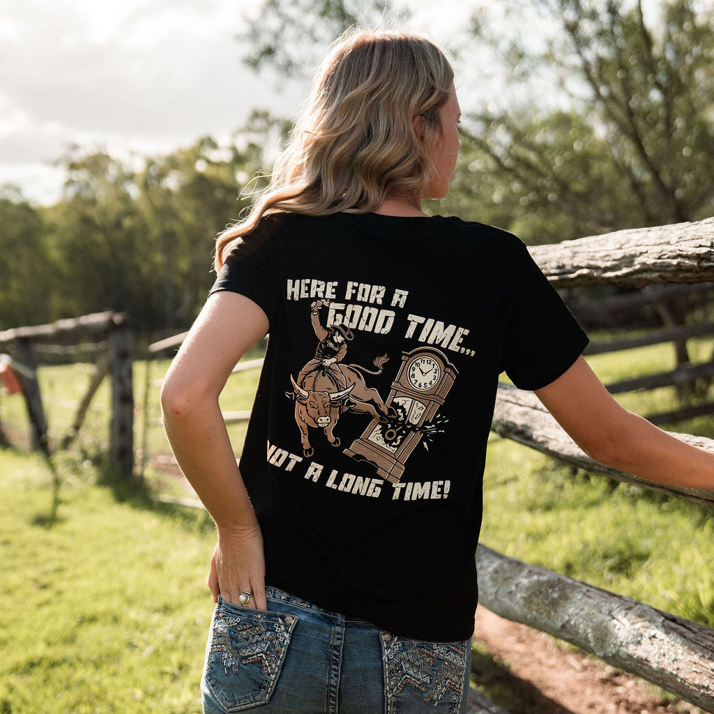 Person wearing a black t-shirt with text and graphics in an outdoor setting